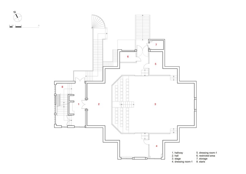 Floor plan drawing showing a central stage area with seating rows and adjacent dressing and storage rooms