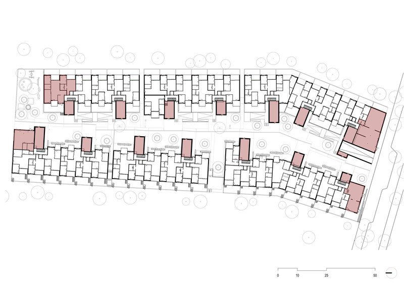 Site plan drawing showing two parallel residential bars with pink-toned communal cores and surrounding trees