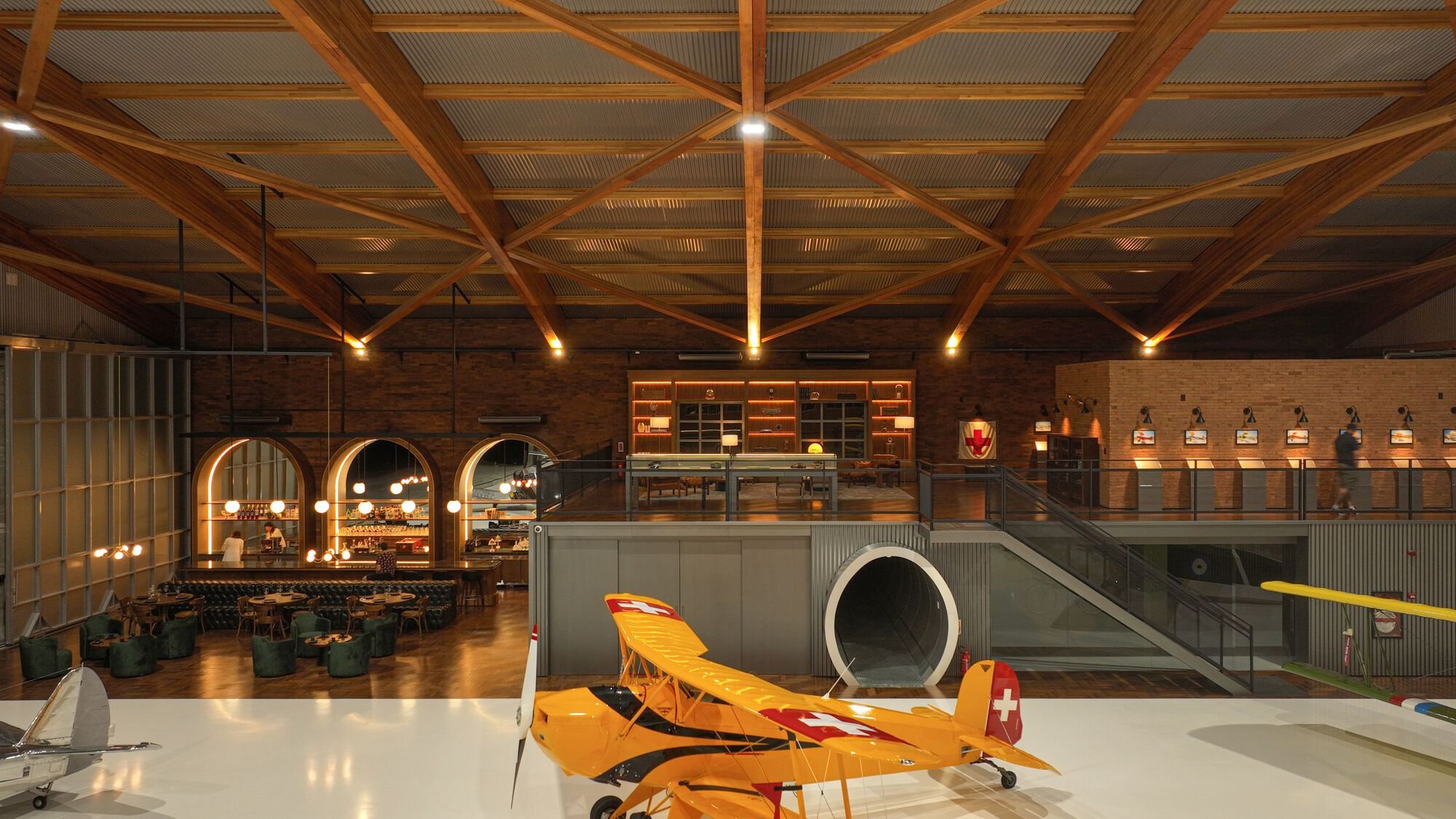 Nola Arquitetura Builds Brazil's Largest Laminated Wood Arch to Shelter Vintage Aircraft