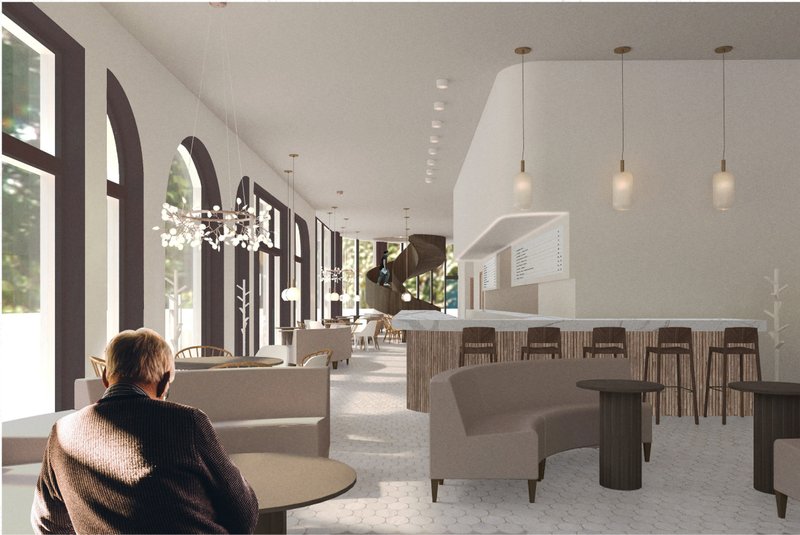 Main seating area with arched windows, soft daylight, and a central coffee bar defining the cafe’s warm social atmosphere.