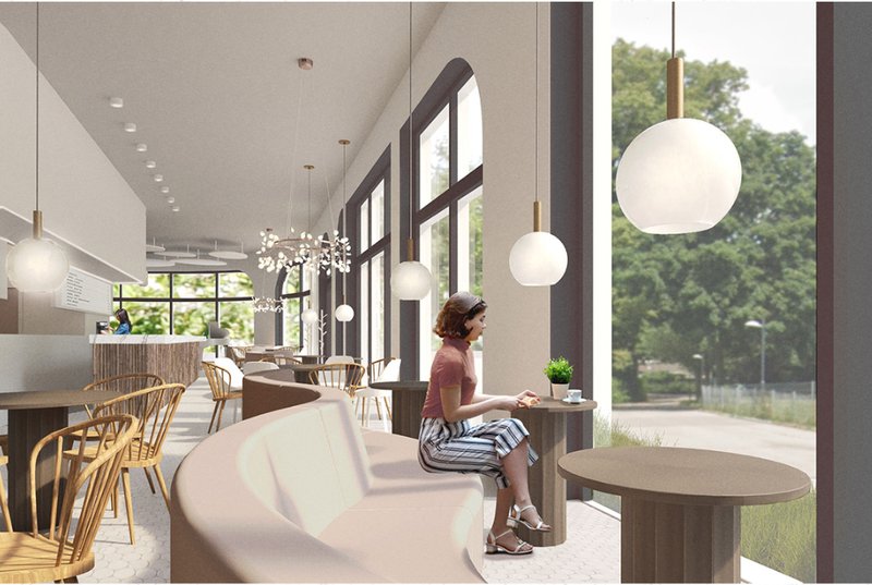 Window-side seating frames greenery outside, offering a calm spot for coffee, work, and quiet conversation.
