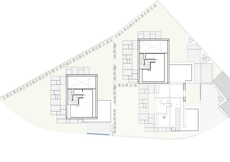 Site plan drawing showing two residential buildings with central access road and tree symbols