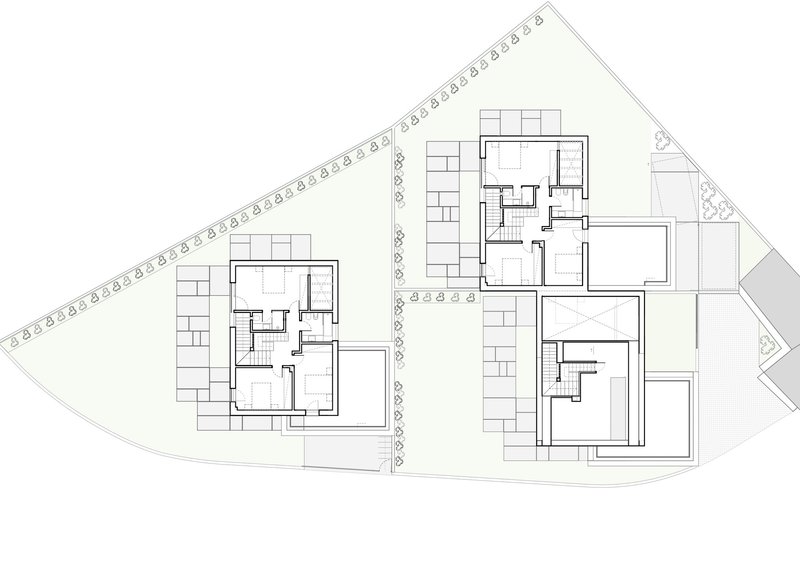 Floor plan drawing showing two residential units with central staircases and surrounding landscaping