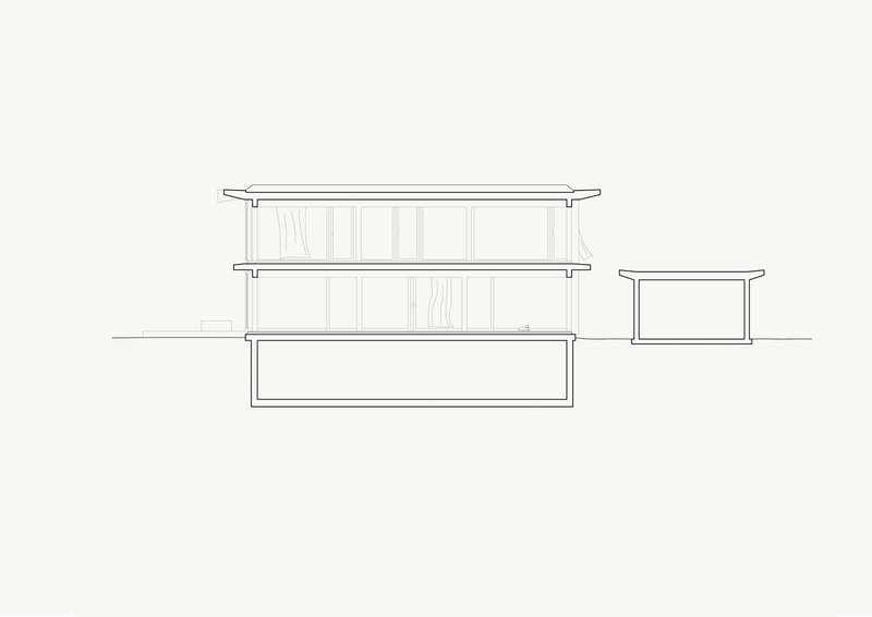 Section drawing revealing two-story volume with basement and single-story adjacent structure
