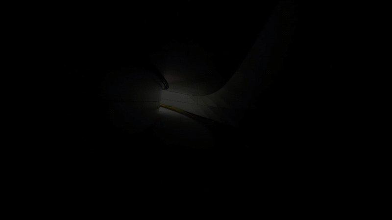 Narrow beam of light illuminating a person walking through a darkened corridor