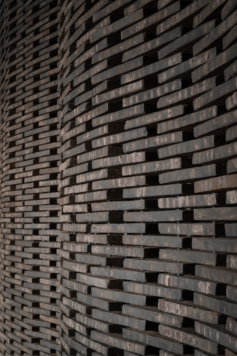 Close-up of textured brick wall with staggered courses creating a rhythmic pattern