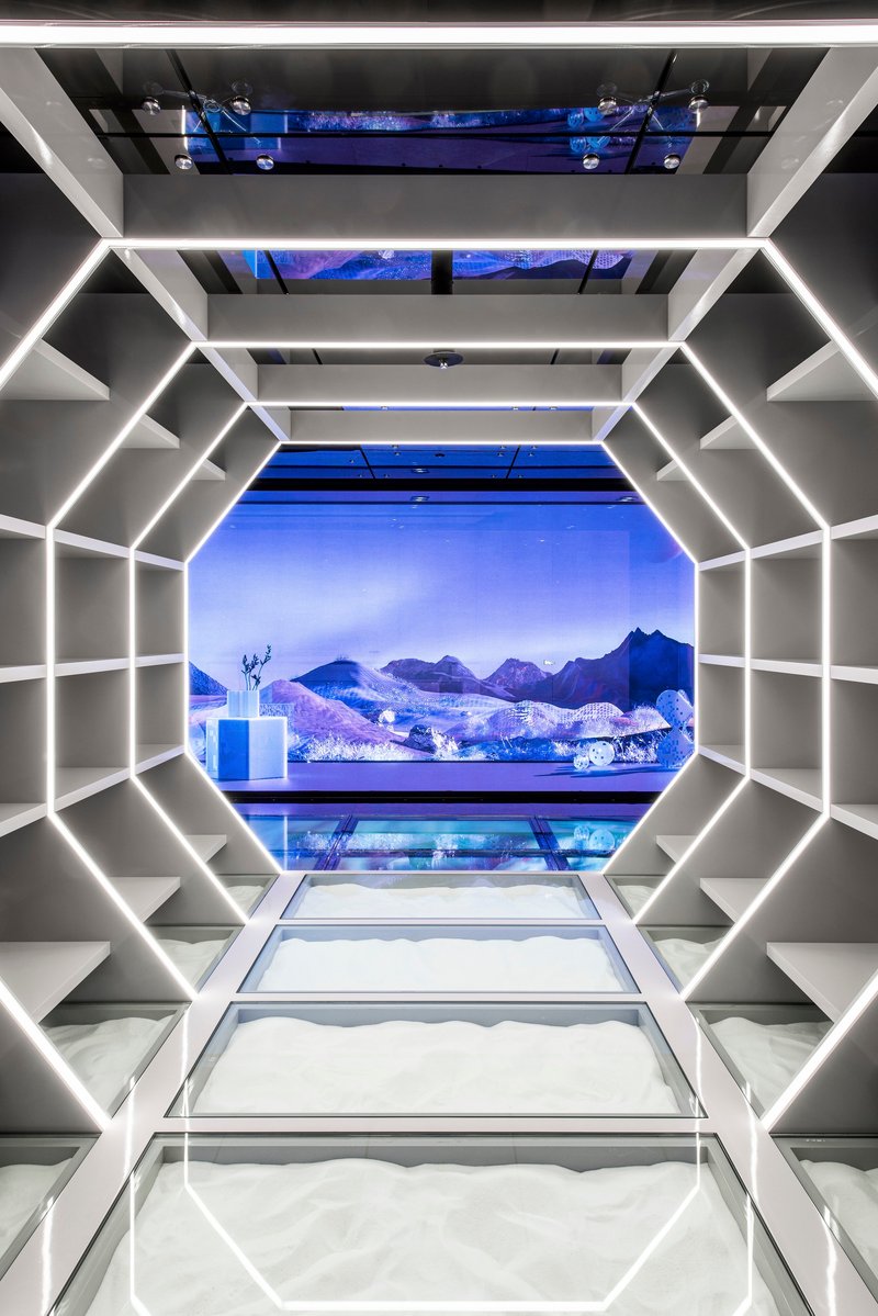 LED-edged octagonal passageway framing a blue projected mountain landscape at its terminus