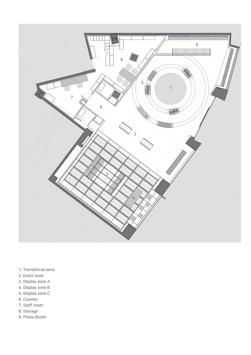 Floor plan drawing showing irregular perimeter with circular counter zone and grid of display tables