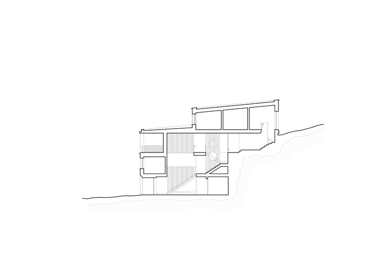 Section drawing showing split-level interior spaces with a central staircase connecting multiple floors