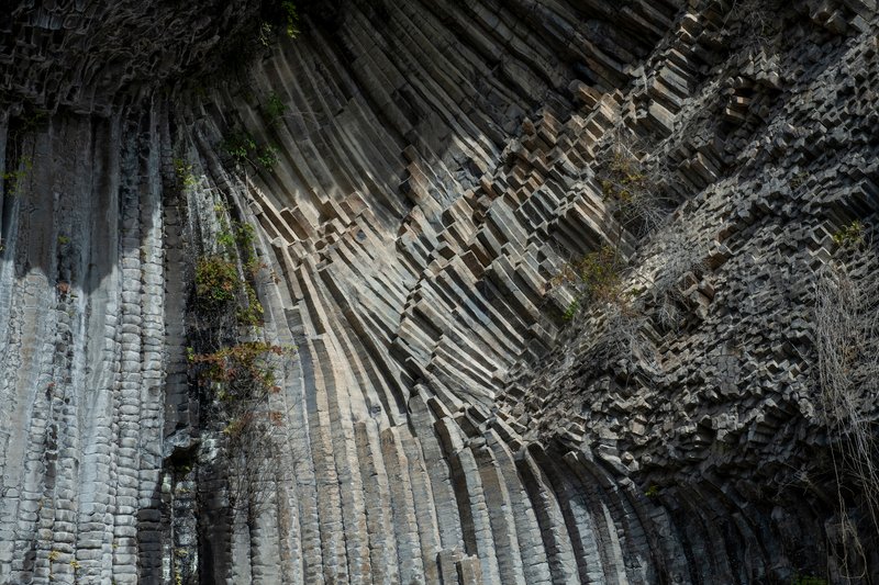 Overhead view of columnar basalt formations creating angular patterns across the rock face