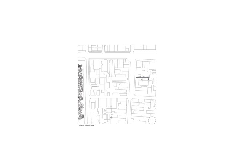 Site plan drawing showing the building footprint within a dense urban block with tree-lined street