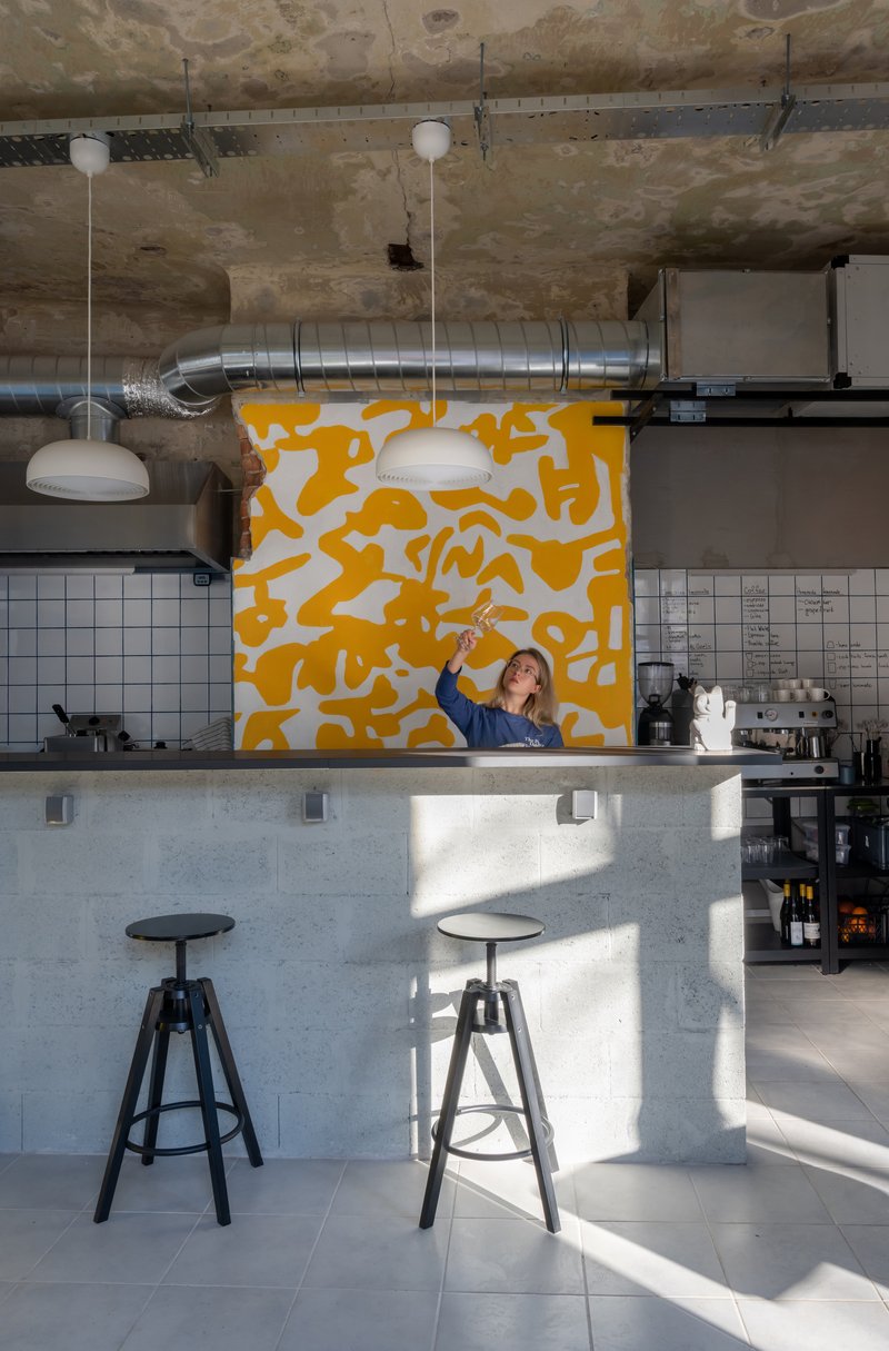 FREYA Architects Strips a Belgrade Storefront Back to Raw Concrete for a Youth-Driven Eatery