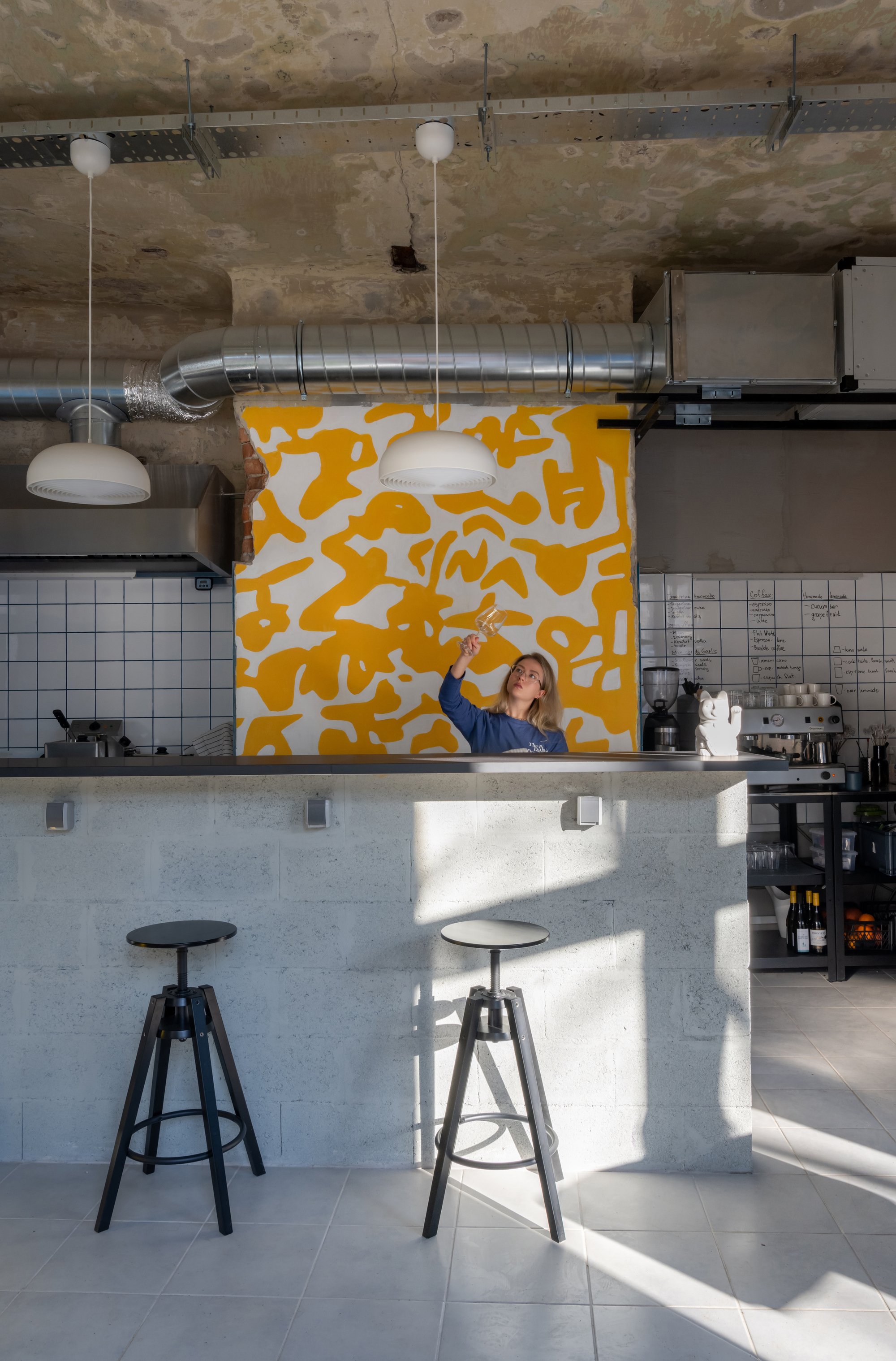 FREYA Architects Strips a Belgrade Storefront Back to Raw Concrete for a Youth-Driven Eatery
