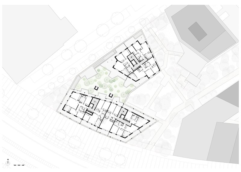 Upper floor plan drawing showing residential units flanking a central landscaped courtyard with trees