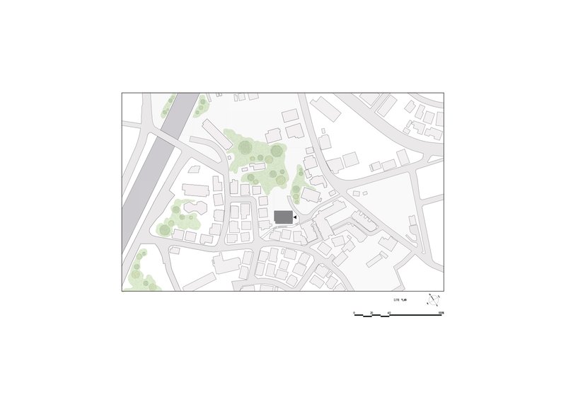 Site plan drawing showing the building footprint within a residential neighborhood with surrounding streets and greenspace