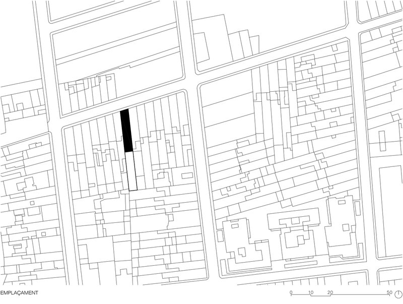 Site plan drawing showing a single filled footprint among surrounding urban blocks and street grid