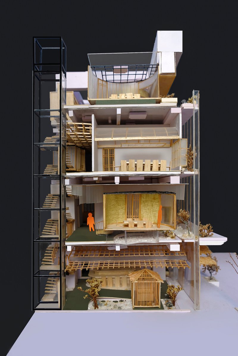 Longitudinal section model revealing stacked floors with external stair tower and interior courtyard plantings