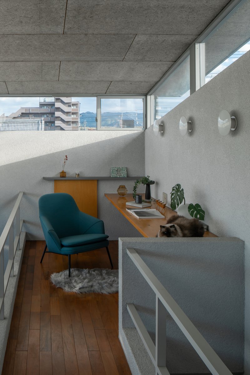 Mezzanine workspace with concrete countertop and clerestory windows overlooking distant mountains