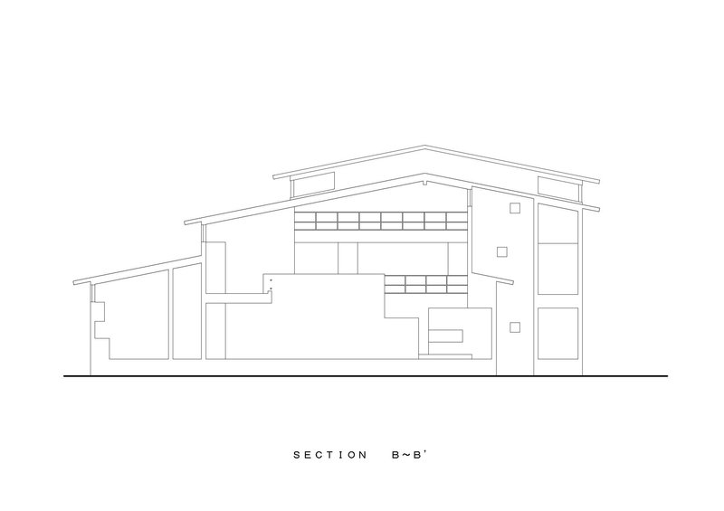 Section drawing showing split-level interior spaces under sloping rooflines with clerestory windows