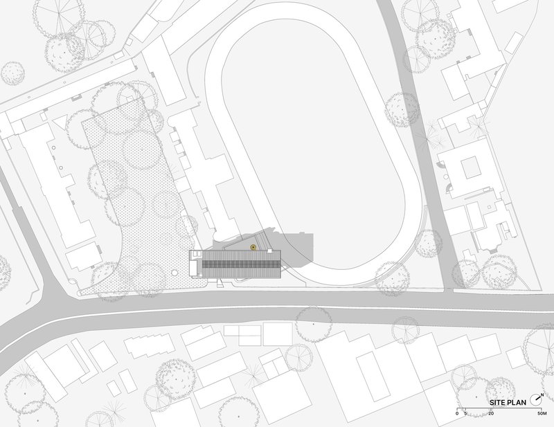 Site plan drawing showing raised building adjacent to running track and landscaped surroundings