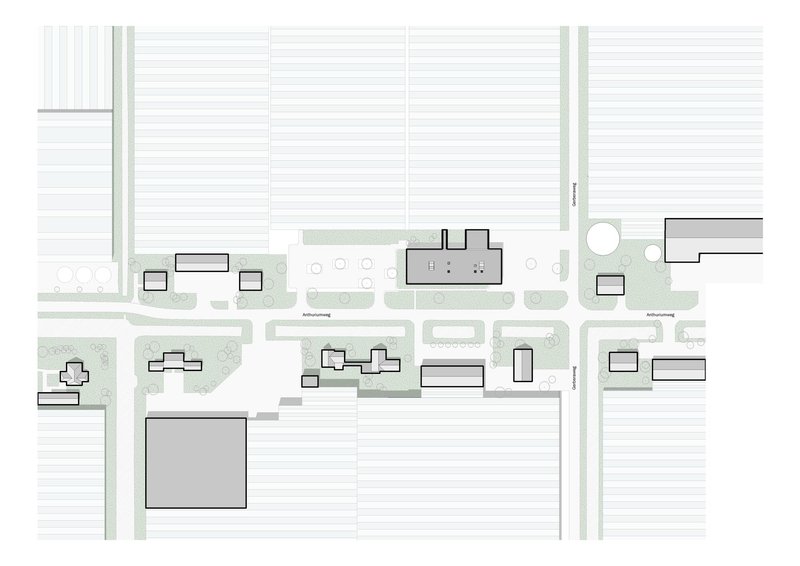 Site plan drawing showing building footprints and landscaped areas within surrounding street grid