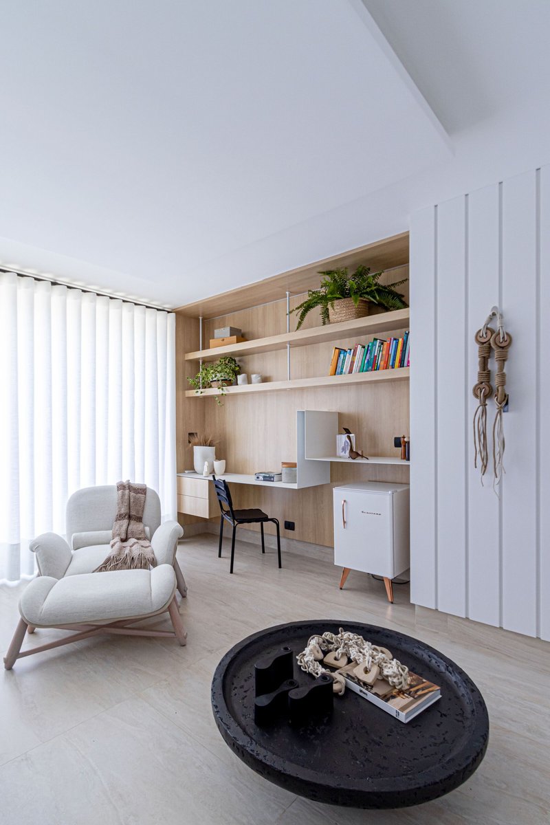 Home office nook with built-in timber shelving and vertical white panel wall