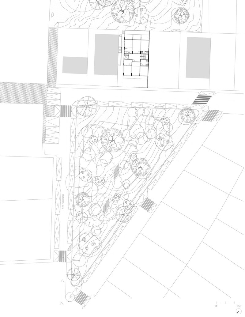 Site plan drawing showing triangular landscaped garden with tree symbols adjacent to building footprint and street edge