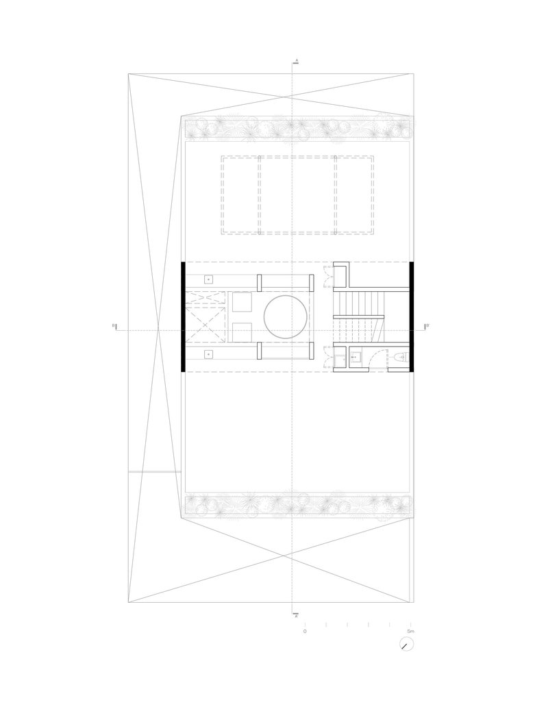Floor plan showing a central circular element flanked by staircases within a rectangular volume and terraces