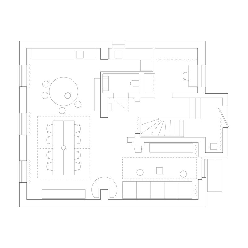 Floor plan drawing showing open living and dining areas with central stair and bathroom core