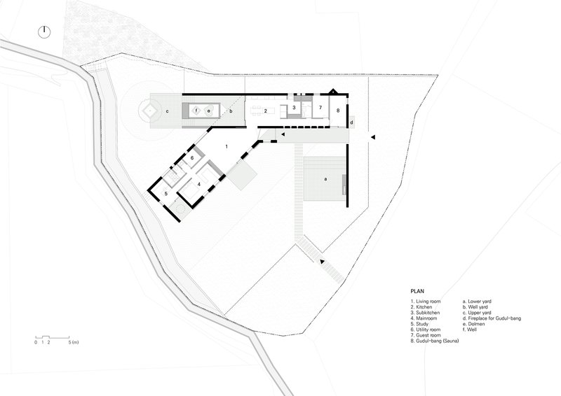 Site plan drawing showing angled building volumes on an irregular lot with access road