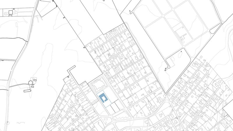 Site plan drawing showing a rectangular building footprint within a diagonal urban street grid