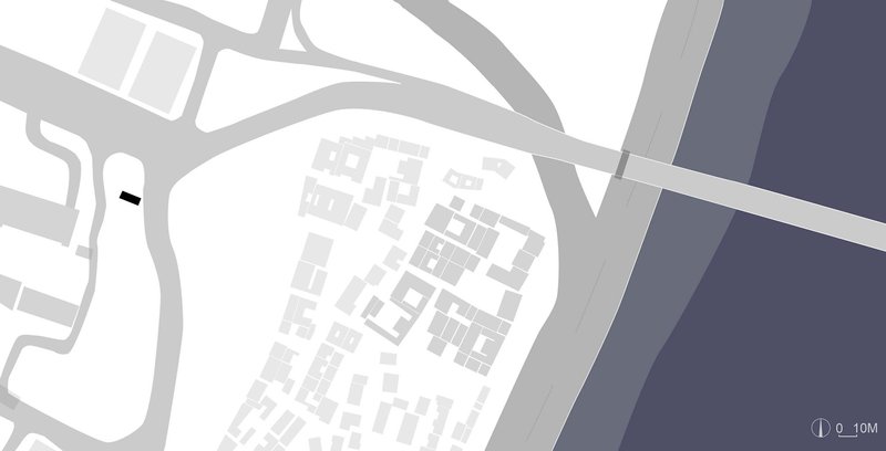 Site plan drawing depicting a cluster of buildings on a peninsula bounded by roadways and water