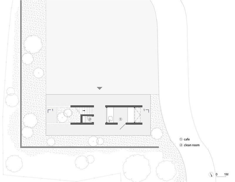 Ground floor plan showing a cafe and clean room within landscaped grounds with circular tree symbols