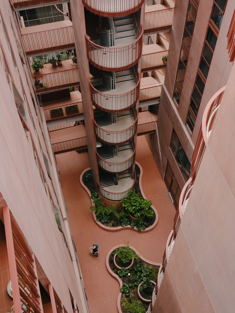 Looking down into the internal courtyard with curved planting beds and cylindrical balcony tower
