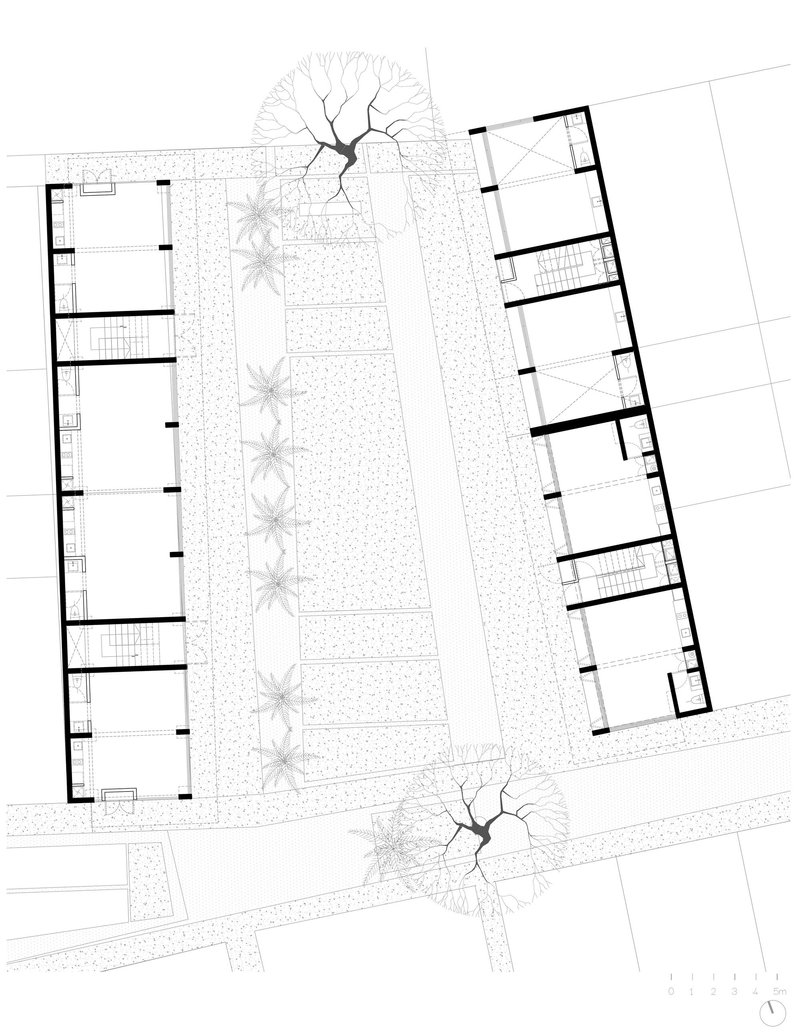 Floor plan drawing showing two residential wings flanking a central landscaped courtyard with palm trees