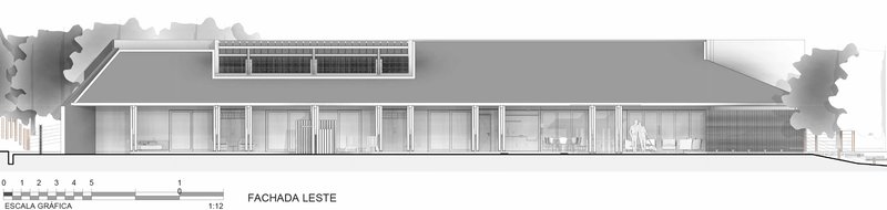 East elevation drawing showing long horizontal facade with clerestory band and overhanging roof