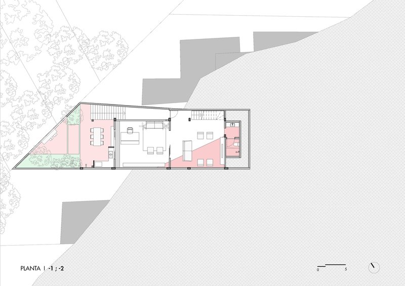 Floor plan drawing showing open living and dining spaces with central stair and terraces