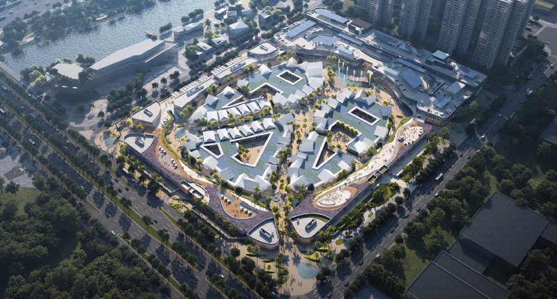 Aerial rendering of the courtyard complex with white roofs, landscaping, and surrounding urban blocks