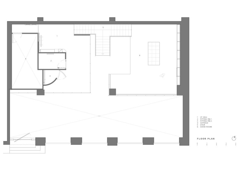 Floor plan drawing showing upper level with bathroom alcove and open workspace with terrace below