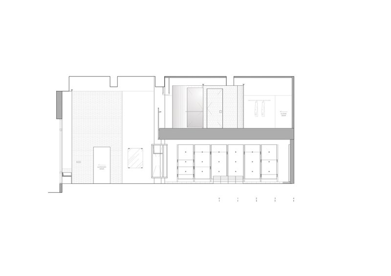 Section drawing showing a narrow vertical circulation core separating spaces with a courtyard on the left
