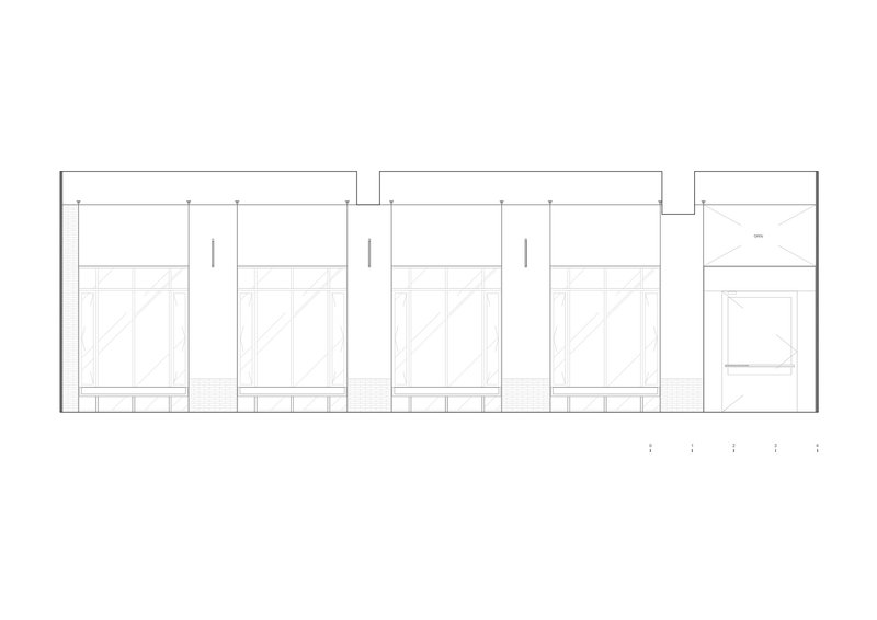 Elevation drawing showing a series of four identical storefronts with transom windows above