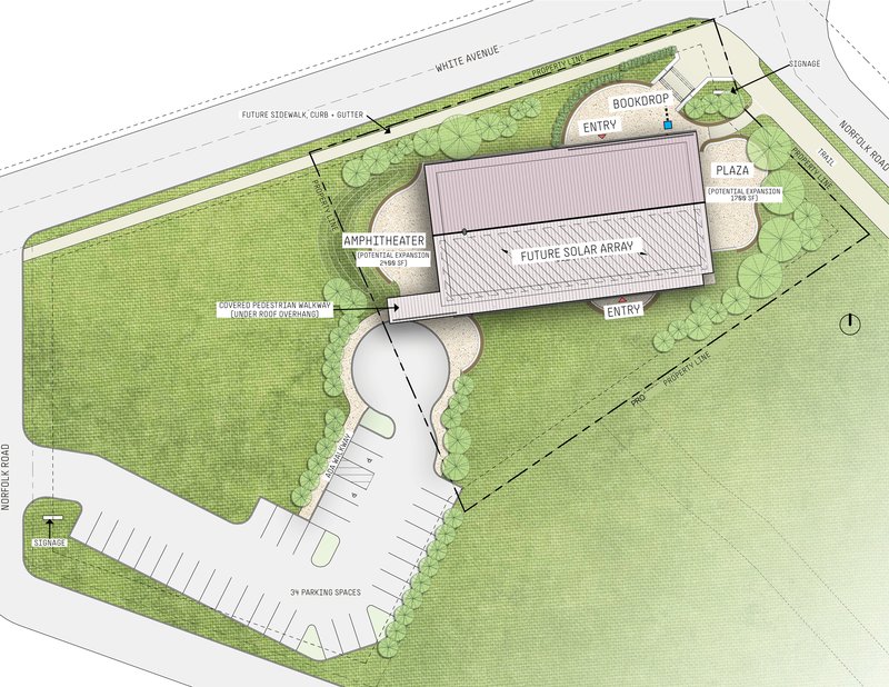 Site plan drawing showing an amphitheater building surrounded by green lawn and parking areas