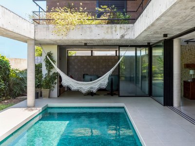 Fernandes Atem Arquitetos Wraps an Exposed Concrete House Around Its Own Pool Courtyard in Eusébio