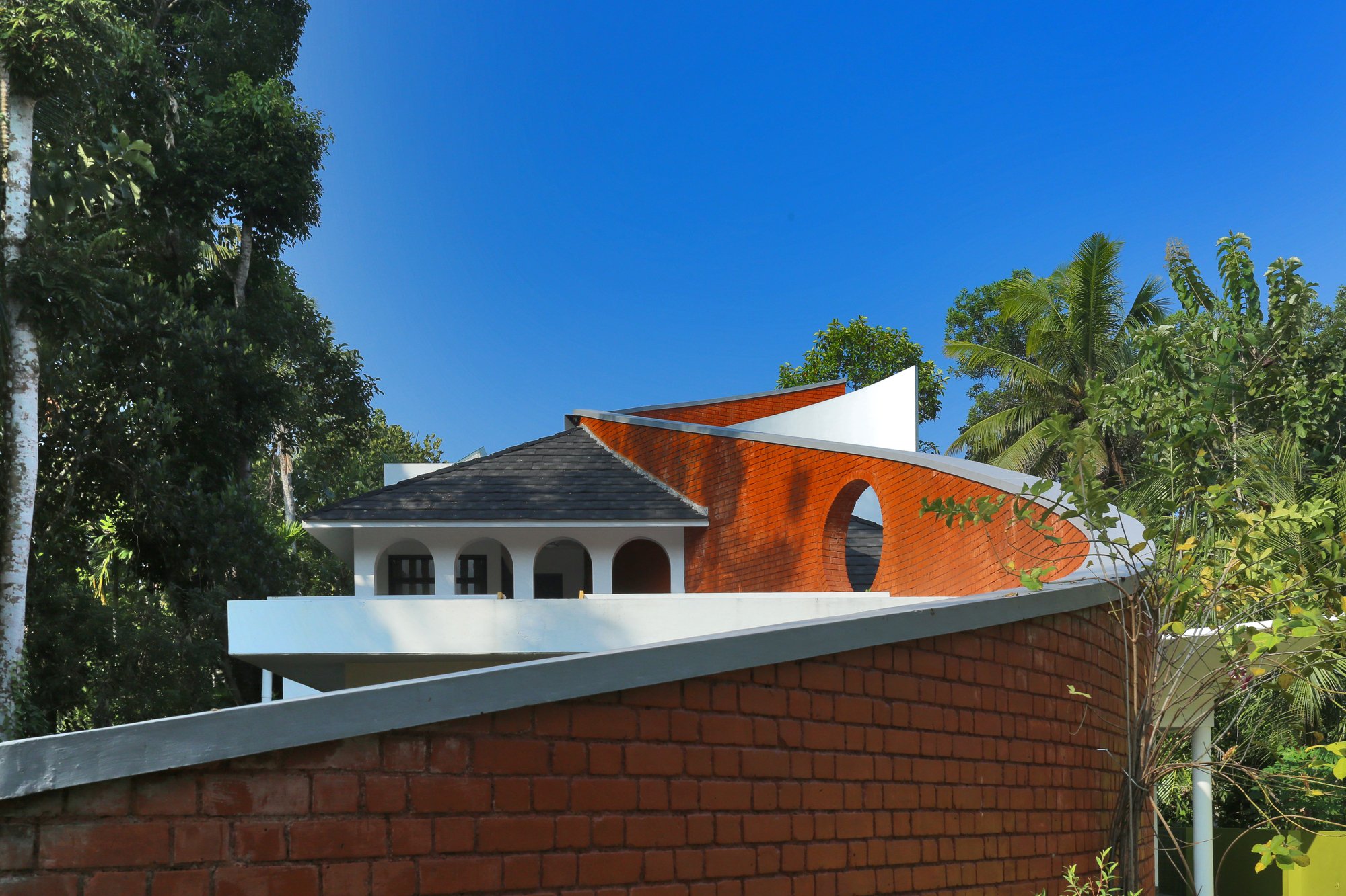 S Squared Architects Use a Freehand Curved Wall to Split Sacred and Domestic Life in Kerala