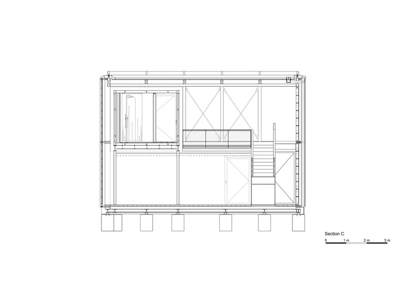 Section drawing revealing interior staircase and upper level mezzanine with diagonal cross-bracing in timber frame
