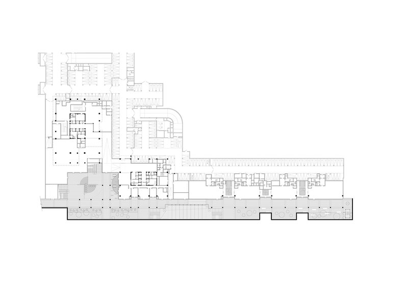 Floor plan drawing showing an irregular L-shaped layout with columnar grid and extended wing