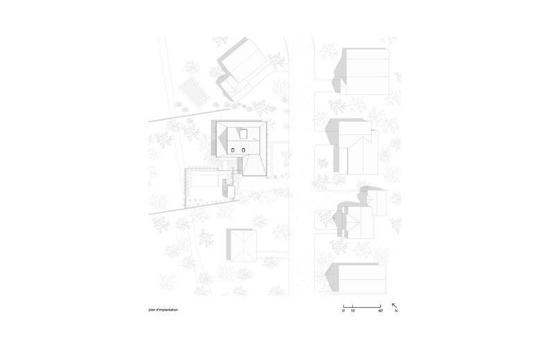 Site plan drawing showing building footprints and surrounding landscape with trees indicated in plan view