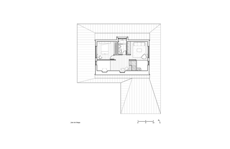 Upper floor plan drawing showing two bedrooms with central bathroom and staircase connection to lower level