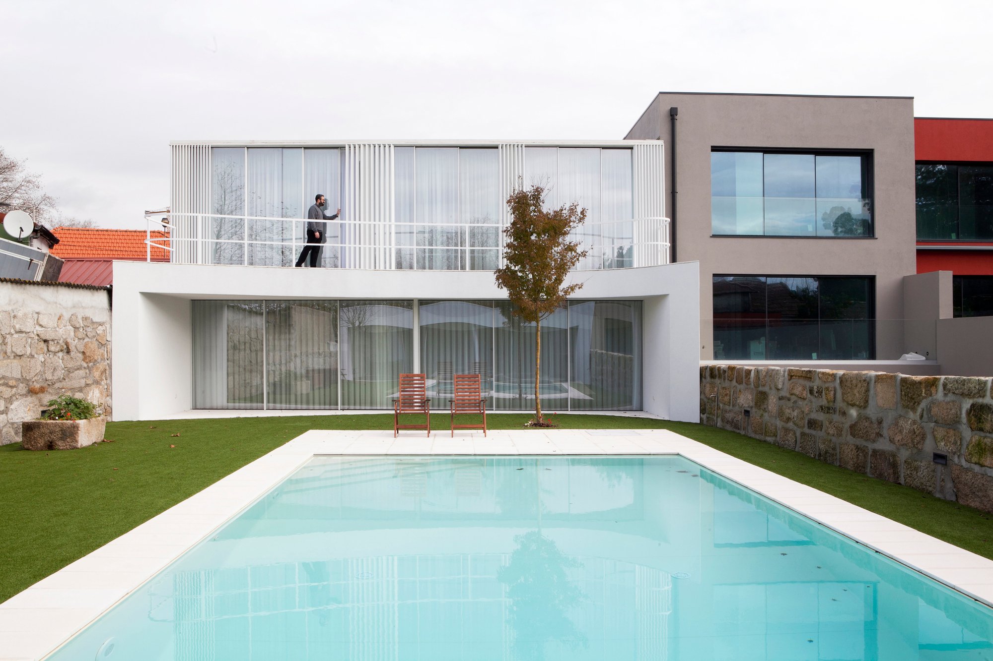 A2OFFICE Curves a Porto House Around a Preserved Tree and an Open Patio