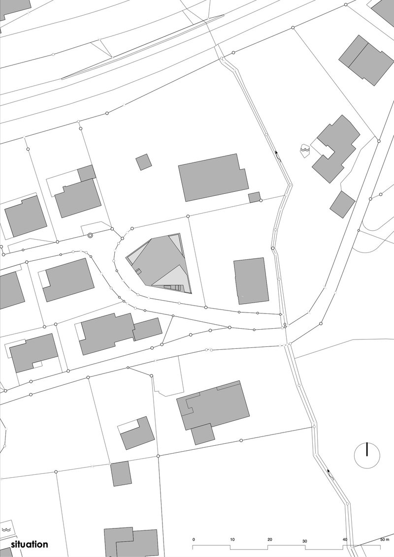 Site plan drawing showing the building footprint within a curved street network
